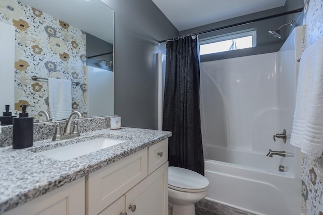 full bathroom featuring shower / bathtub combination with curtain, vanity, and toilet