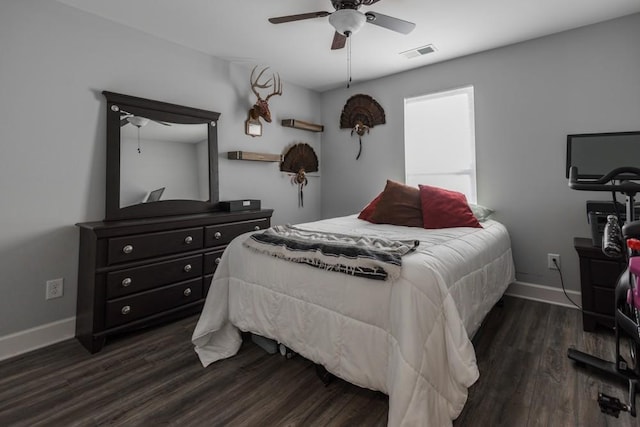 bedroom with dark hardwood / wood-style flooring and ceiling fan