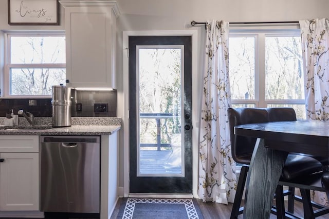 doorway to outside featuring sink, dark hardwood / wood-style flooring, and plenty of natural light