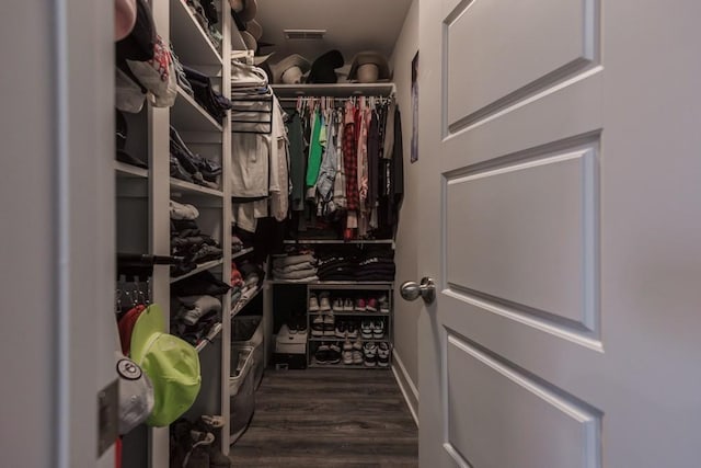 walk in closet featuring dark wood-type flooring