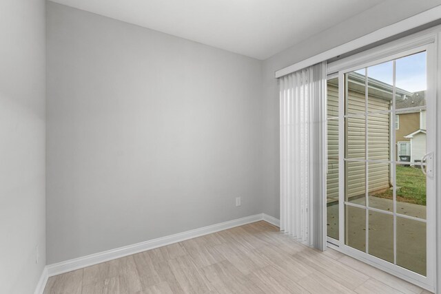 empty room with light hardwood / wood-style flooring