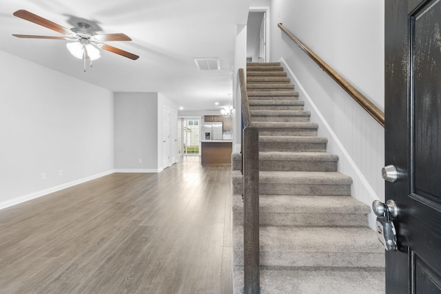 foyer entrance with ceiling fan and hardwood / wood-style floors