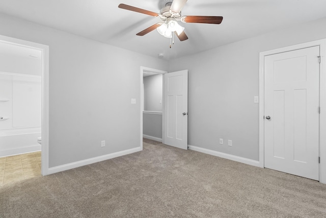 unfurnished bedroom featuring connected bathroom, ceiling fan, and light carpet