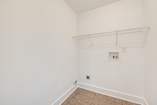 washroom featuring electric dryer hookup, light tile patterned floors, and washer hookup