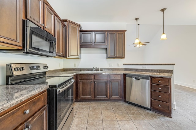 kitchen featuring hanging light fixtures, sink, ceiling fan, light tile patterned floors, and appliances with stainless steel finishes