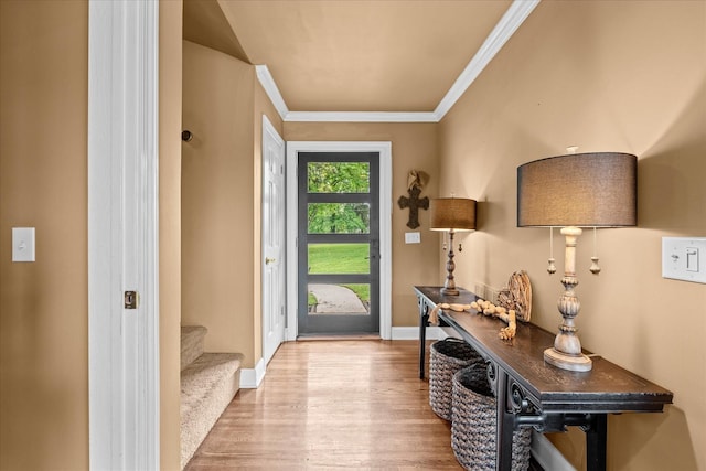 doorway to outside with light wood-type flooring and ornamental molding