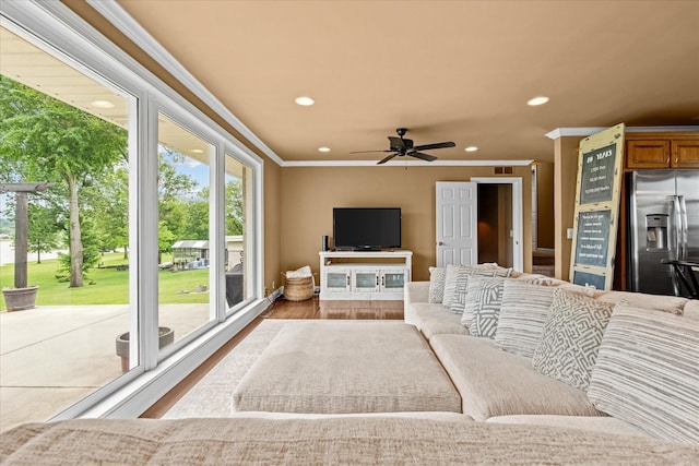 living room featuring light hardwood / wood-style flooring, ceiling fan, and crown molding