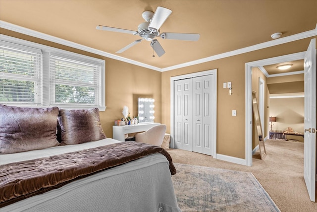 bedroom featuring ceiling fan, light colored carpet, ornamental molding, and a closet