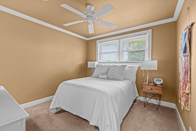 carpeted bedroom featuring ceiling fan and ornamental molding