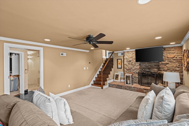 living room featuring ceiling fan, ornamental molding, and a fireplace