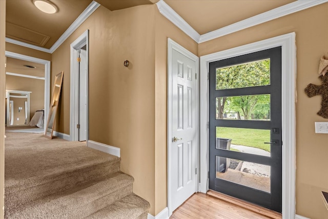 foyer entrance with light hardwood / wood-style floors and ornamental molding