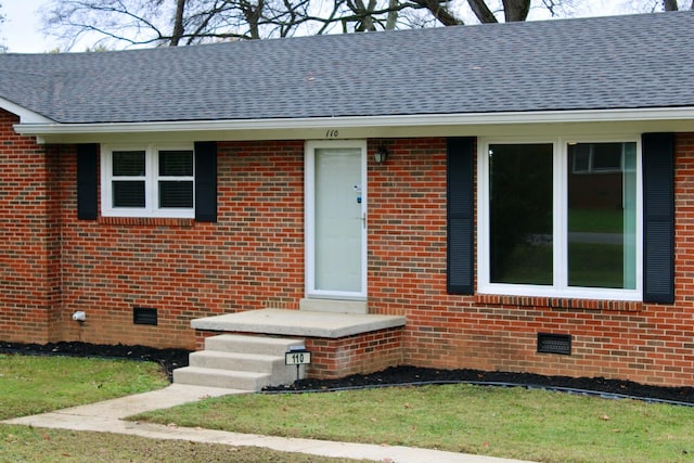 doorway to property with a yard