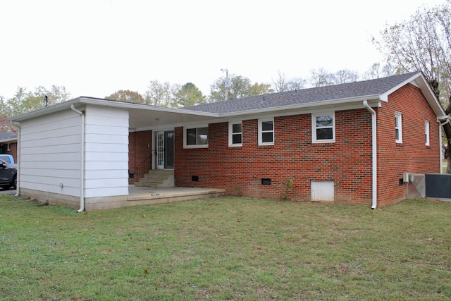 rear view of property with a lawn and a patio