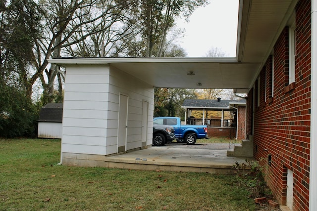 view of parking with a yard and a carport