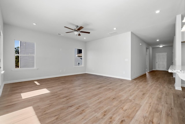 empty room featuring ceiling fan and light hardwood / wood-style floors