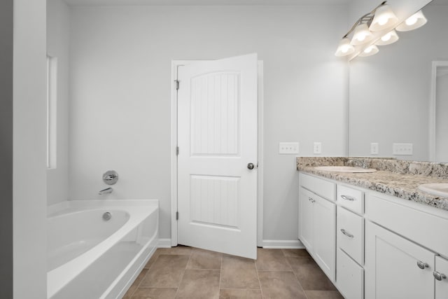 bathroom with tile patterned floors, vanity, and a bathing tub