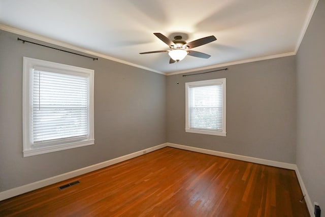 unfurnished room featuring crown molding, dark hardwood / wood-style flooring, and ceiling fan