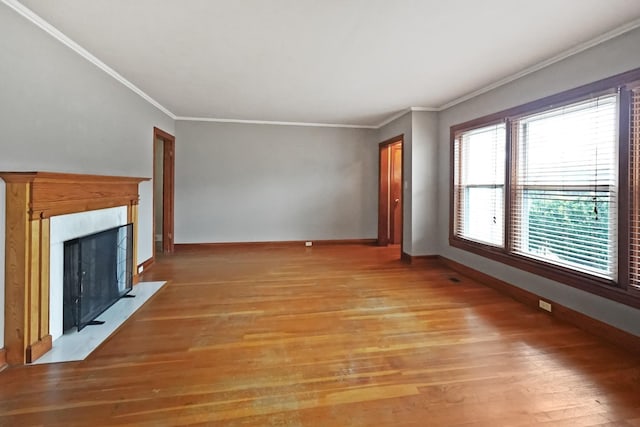 unfurnished living room with crown molding and light wood-type flooring