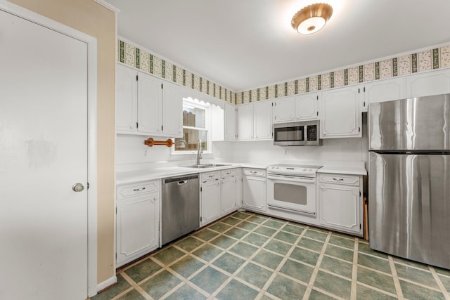 kitchen featuring white cabinets, appliances with stainless steel finishes, and sink