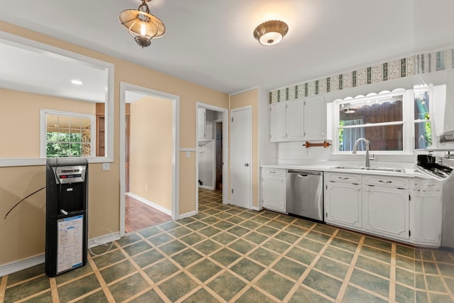 kitchen with dishwasher, white cabinets, and sink