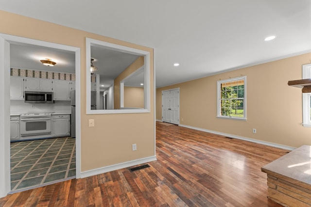 kitchen with dark hardwood / wood-style flooring and white electric range oven