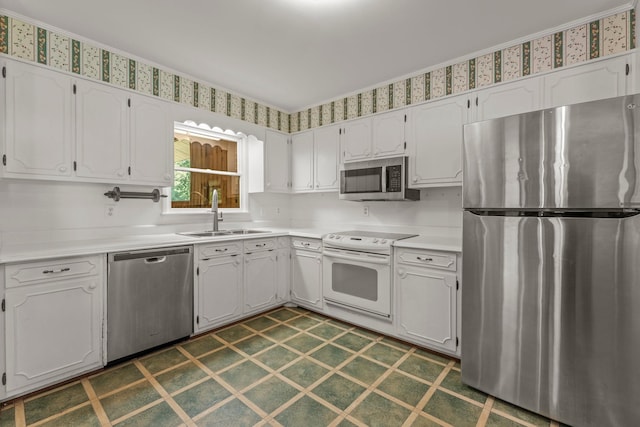 kitchen with sink, white cabinets, and appliances with stainless steel finishes