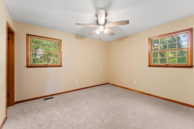 carpeted spare room with ceiling fan