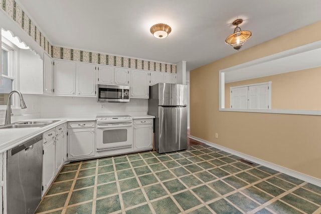 kitchen featuring sink, white cabinets, and stainless steel appliances