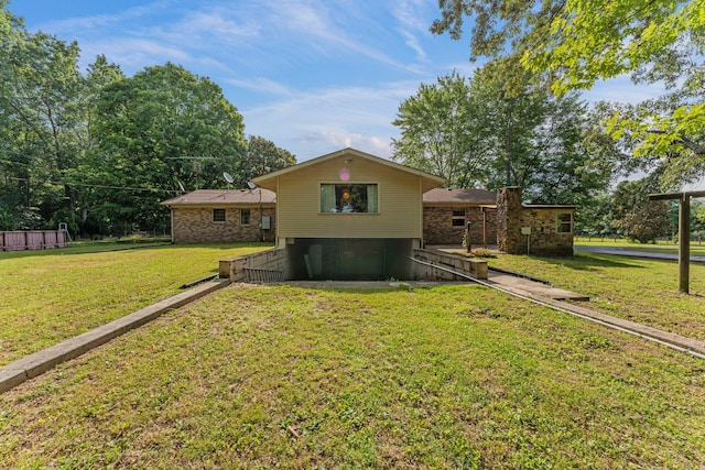 rear view of house featuring a lawn