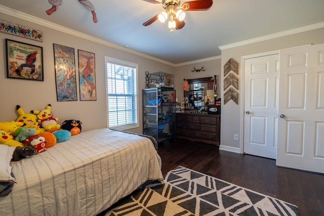 bedroom featuring dark hardwood / wood-style flooring, ceiling fan, and ornamental molding