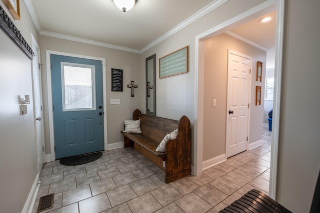 foyer entrance with light tile patterned floors and crown molding