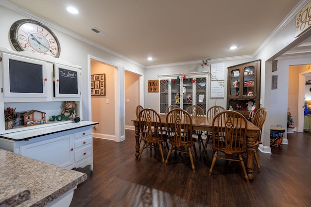 dining area featuring dark hardwood / wood-style floors and crown molding