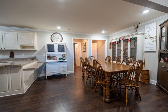 dining room with crown molding and dark wood-type flooring