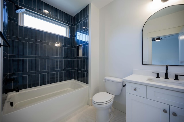 full bathroom featuring vanity, tile patterned floors, tiled shower / bath, ceiling fan, and toilet