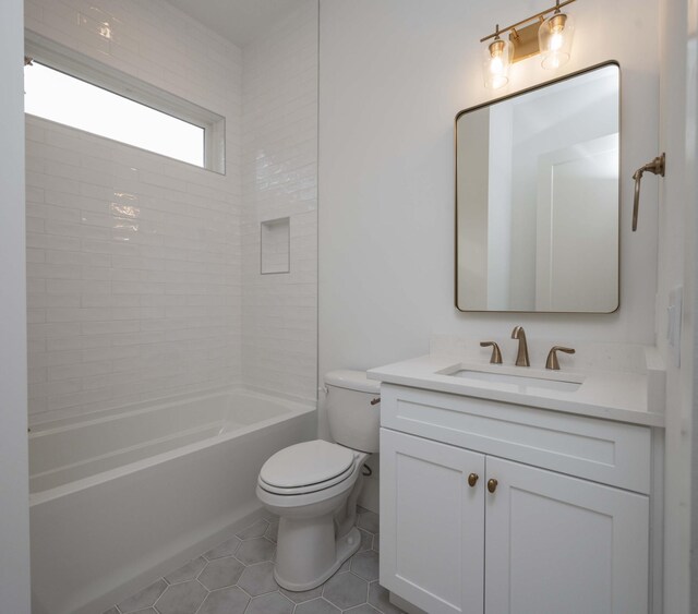 full bathroom featuring toilet, vanity, tile patterned floors, and shower / washtub combination