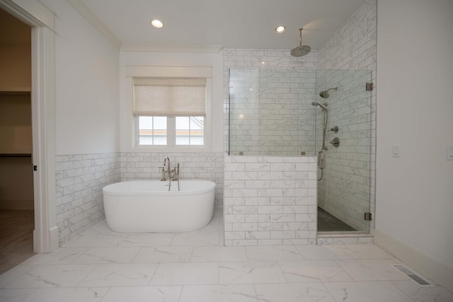 bathroom featuring tile walls and independent shower and bath