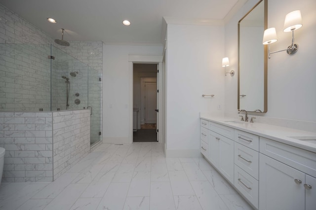 bathroom with crown molding, vanity, and a shower with shower door