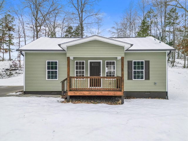 view of snow covered rear of property