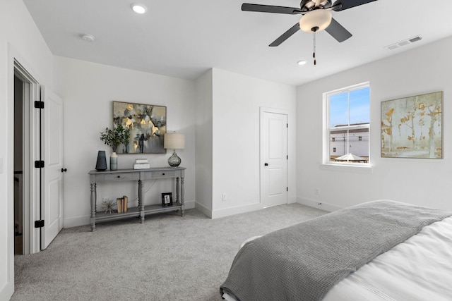 bedroom with ceiling fan and light carpet