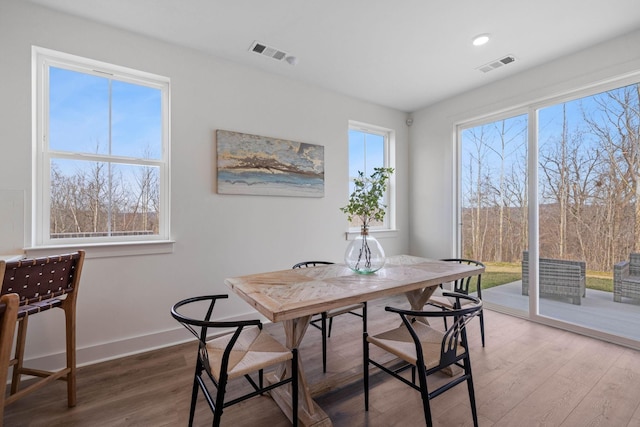 dining area with hardwood / wood-style floors and a healthy amount of sunlight