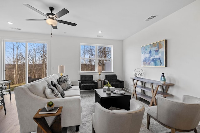 living room with ceiling fan and light hardwood / wood-style floors