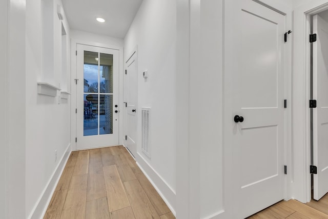 corridor with light wood-type flooring