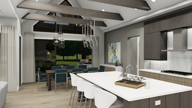 kitchen featuring backsplash, a center island with sink, wall chimney exhaust hood, and stainless steel gas stovetop