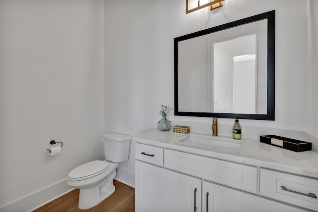 bathroom featuring vanity, toilet, and hardwood / wood-style floors