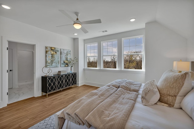 bedroom with lofted ceiling, wood-type flooring, and ceiling fan