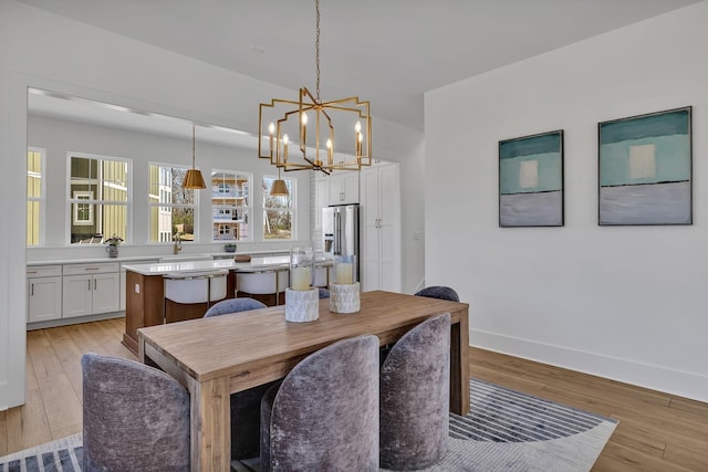 dining room with an inviting chandelier and light hardwood / wood-style floors