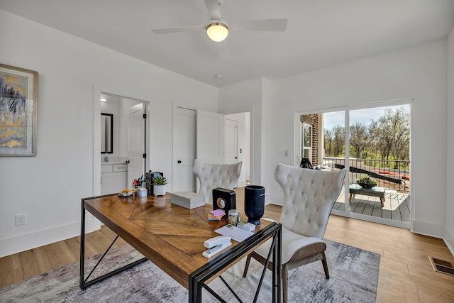 office space with ceiling fan and light wood-type flooring