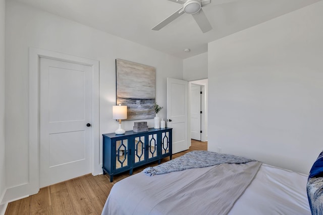 bedroom with hardwood / wood-style floors and ceiling fan