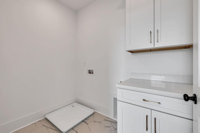 clothes washing area featuring cabinets and washer hookup