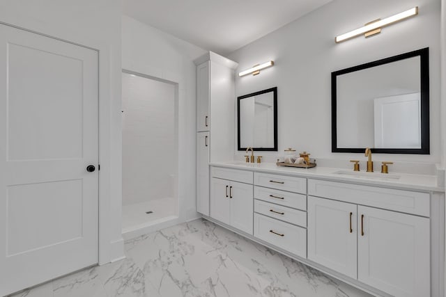 bathroom with vanity and a tile shower